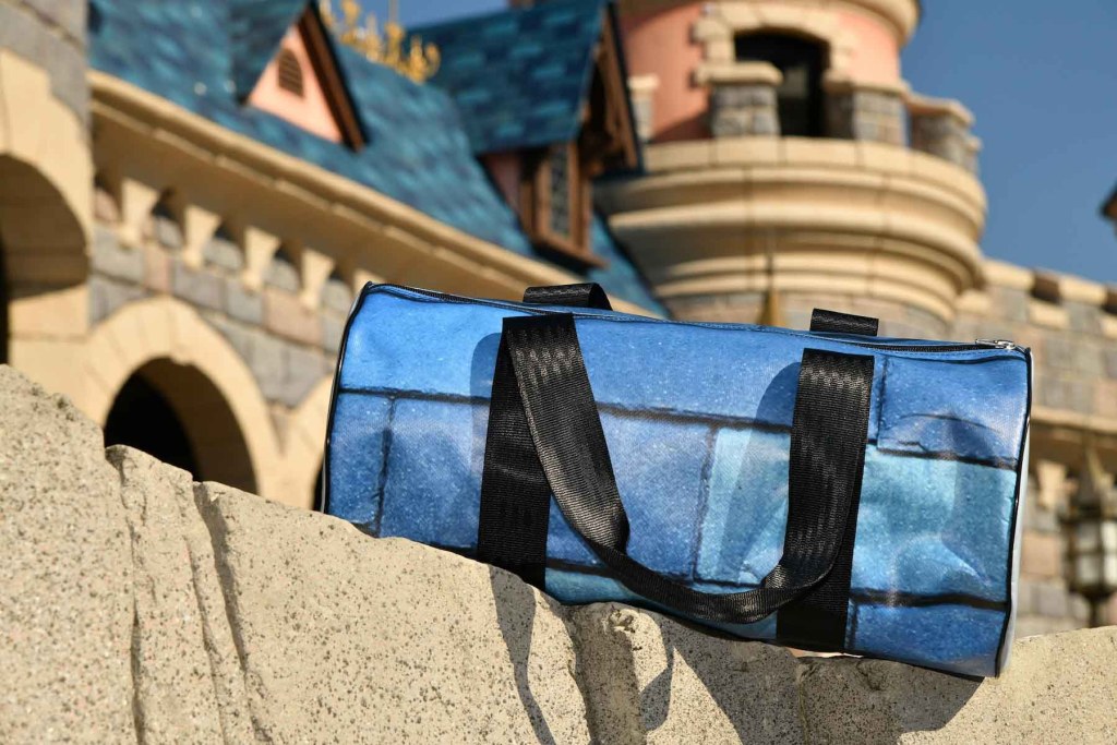 One of the duffle bags from the Sleeping Beauty Castle tarp up-cycling collection. Source: Disney