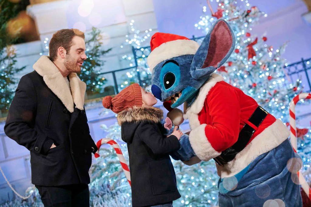 Stitch meeting park goers in his Christmas outfit at Disneyland Paris. Source: Disney